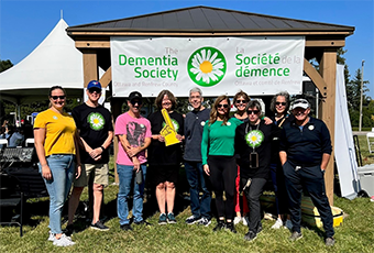 Thumbnail of a group standing in front of the Dementia Society banner.