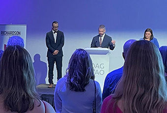 Orange kitten eating wet food